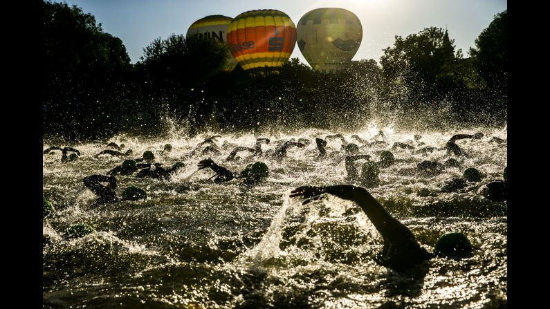 Athletes compete during the swim leg at the DATEV Challenge Roth 2018 triathlon on Sunday, July 1, in Roth, Germany. 