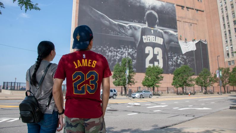 Workers remove the Nike LeBron James banner on Tuesday, July 3, in Cleveland. James has signed with the <a href="index.php?page=&url=http%3A%2F%2Fbleacherreport.com%2Farticles%2F2784397-lebrons-signing-proves-lakers-exceptionalism-wasnt-dead-it-was-just-dormant" target="_blank" target="_blank">Los Angeles Lakers</a>. 