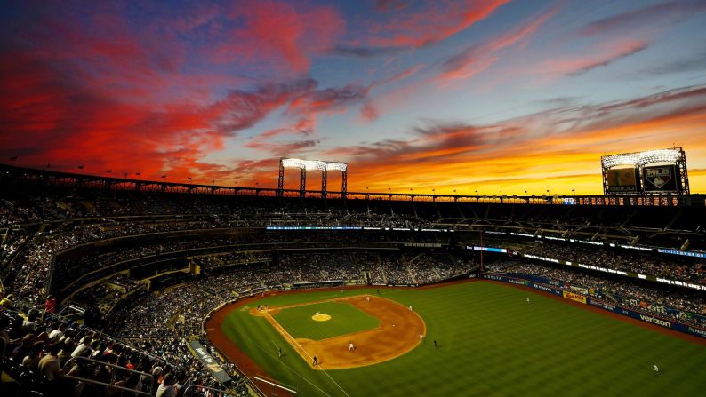 A sunset competes with the game between the New York Mets and the Tampa Bay Rays on Friday, July 6, in New York. 