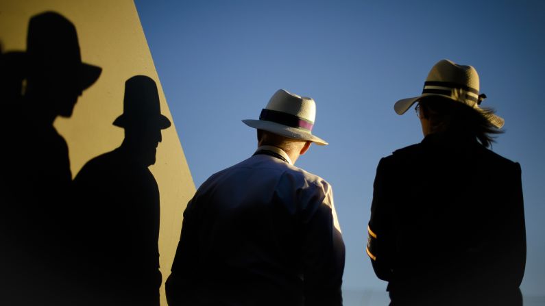 Spectators cast shadows during first round matches at the Wimbledon Tennis Championships in London on Monday, July 2. 