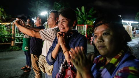 Onlookers watch and cheer as ambulances deliver boys rescued from a cave in northern Thailand to hospital in Chiang Rai, Thailand, after they were transpored by helicopter on July 8, 2018.