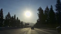A strong morning sun rises over the Ventura Freeway State Route 134 in Burbank, Calif. on Friday, July 6, 2018. Forecasters say temperatures will soar into triple digits throughout almost all of Southern California as a brief but intense heat wave broils the region. (AP Photo/Richard Vogel)