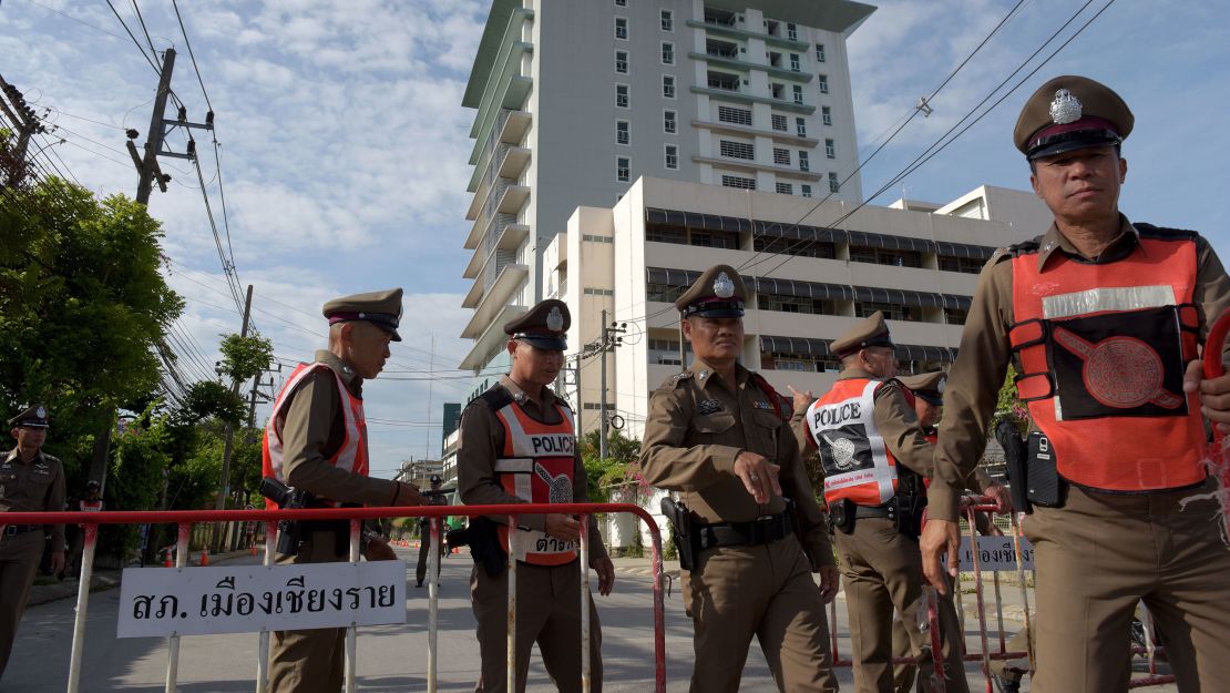 Thai policemen block a road leading to the hospital where the rescued boys are recovering.
