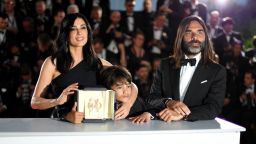 TOPSHOT - Lebanese director and actress Nadine Labaki (L), her husband Lebanese producer Khaled Mouzanar (R) and Syrian actor Zain al-Rafeea pose with the trophy on May 19, 2018 during a photocall after Labaki won the Jury Prize for the film "Capharnaum" at the 71st edition of the Cannes Film Festival in Cannes, southern France. (Photo by Loic VENANCE / AFP)        (Photo credit should read LOIC VENANCE/AFP/Getty Images)