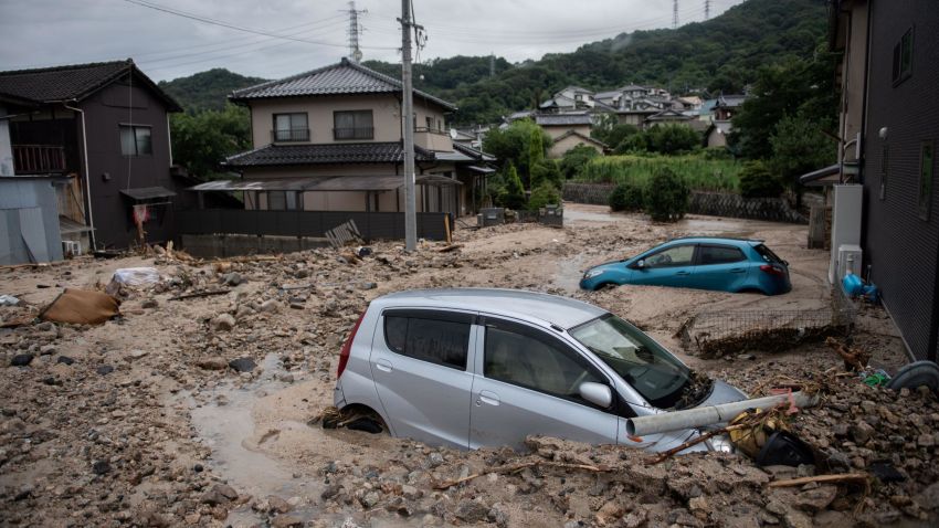 TOPSHOT - A picture shows cars trapped in the mud after floods in Saka, Hiroshima prefecture on July 8, 2018. - Japan's Prime Minister Shinzo Abe warned on July 8 of a "race against time" to rescue flood victims as authorities issued new alerts over record rains that have killed at least 48 people. (Photo by Martin BUREAU / AFP)        (Photo credit should read MARTIN BUREAU/AFP/Getty Images)