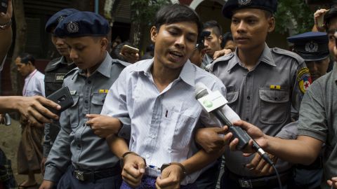 Detained Myanmar journalist Kyaw Soe Oo speaking to reporters under escort by police during a break in trial at a court in Yangon on July 2, 2018.