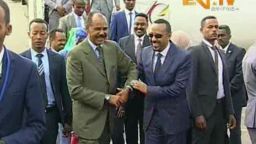 In this grab taken from video provided by ERITV, Ethiopia's Prime Minister Abiy Ahmed, centre right is welcomed by Erirea's President Isaias Afwerki as he disembarks the plane, in Asmara, Eritrea, Sunday, July 8, 2018. With laughter and hugs, the leaders of longtime rivals Ethiopia and Eritrea met for the first time in nearly two decades Sunday amid a rapid and dramatic diplomatic thaw aimed at ending one of Africa's longest-running conflicts. (ERITV via AP)