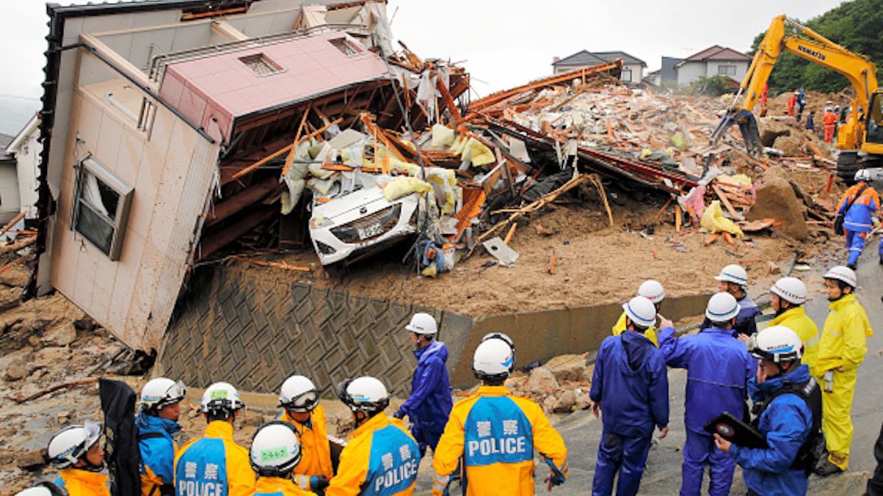 Rescue operations continue at a collapsed house on July 8, 2018 in Kumano, Hiroshima, Japan.