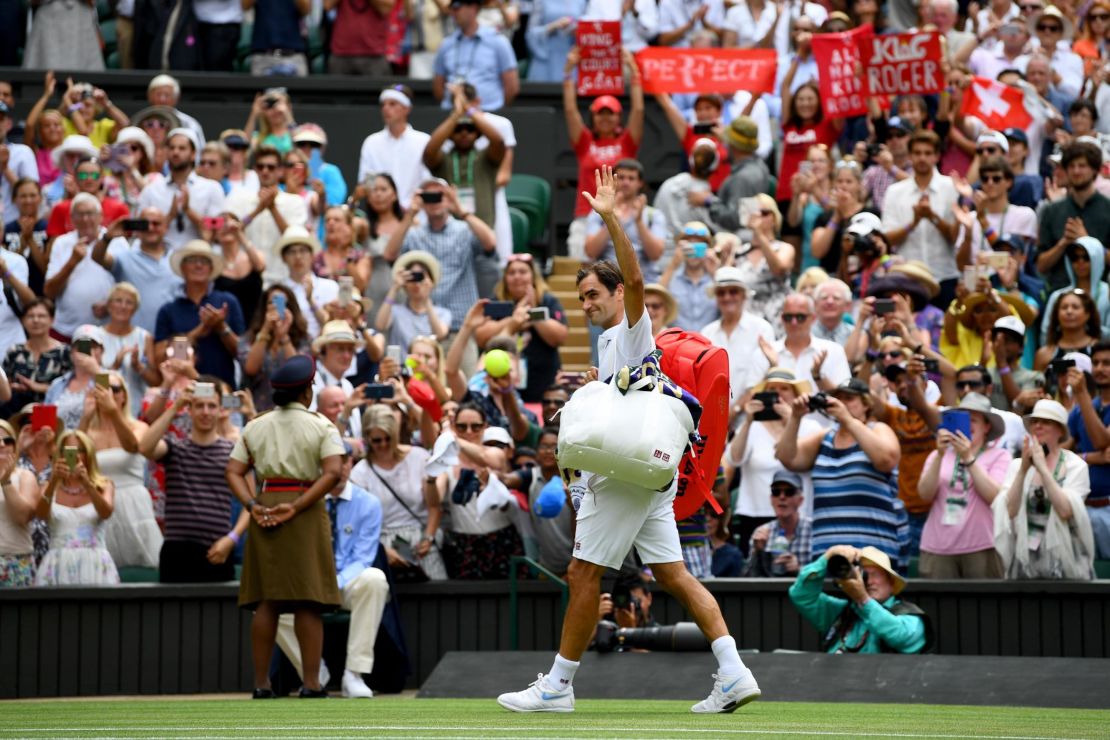 Roger Federer is applauded off court after his win over Adrian Mannarino at Wimbledon. 
