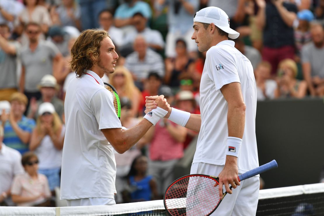 John Isner shakes hands with Stefanos Tsitsipas after their fourth-round Wimbledon match. 