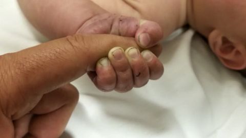 A Missoula County Sheriff's Office photo shows one of the baby's hands with dirt under his fingernails.