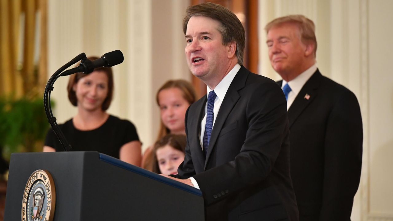 Supreme Court nominee Brett Kavanaugh speaks while his wife Ashley Estes Kavanaugh (L) and US President Donald Trump listens after the announcement of his nomination in the East Room of the White House on July 9, 2018 in Washington, DC. (Photo by MANDEL NGAN / AFP)        (Photo credit should read MANDEL NGAN/AFP/Getty Images)
