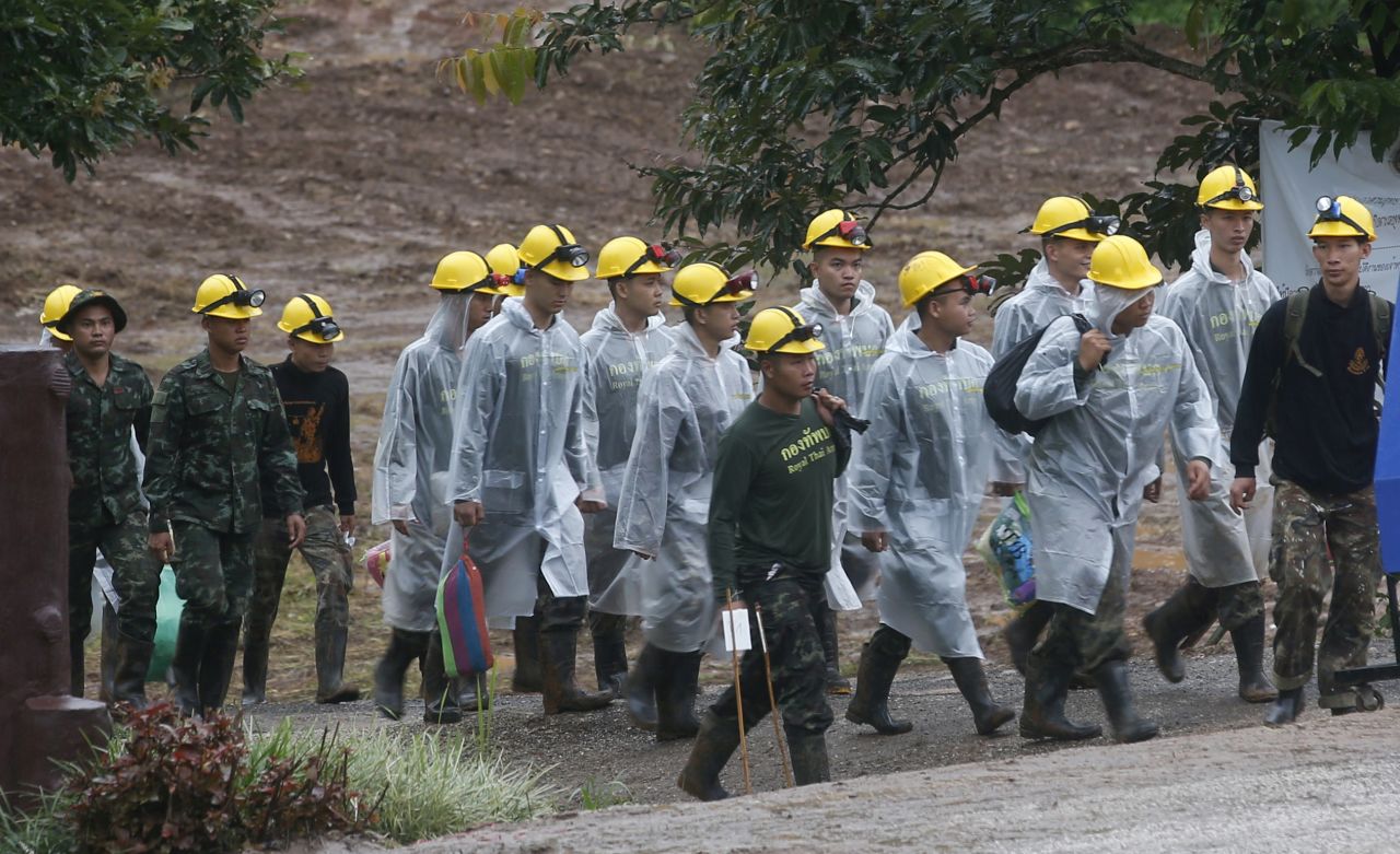 Rescuers walk toward the entrance of the cave as rescue operations resumed on July 10.