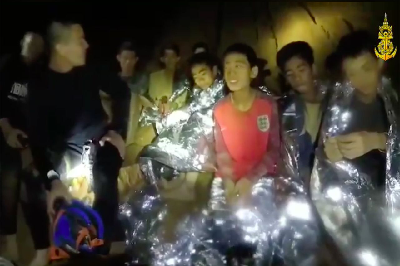 Members of the Royal Thai Navy are pictured with the team inside the cave.