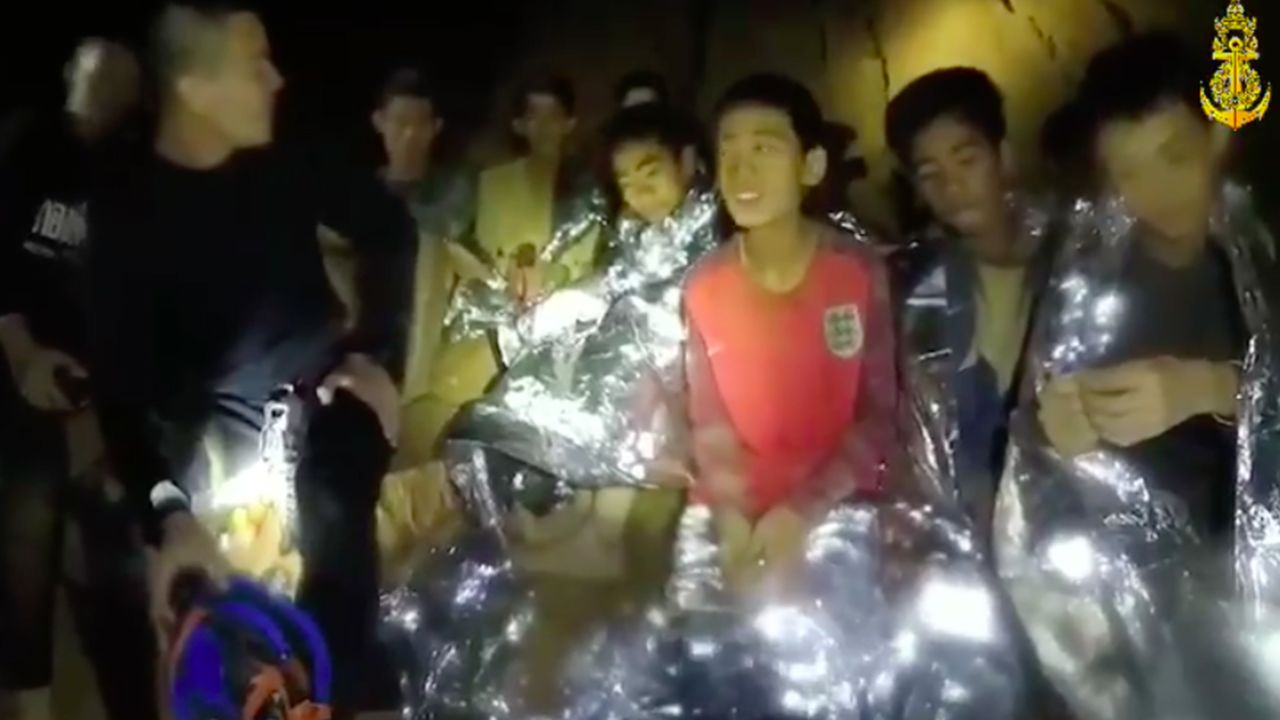 Members of the Royal Thai Navy are pictured with the 12 schoolboys, members of a local soccer team, and their coach, who were trapped in the Tham Luang Cave network in Northern Thailand. 