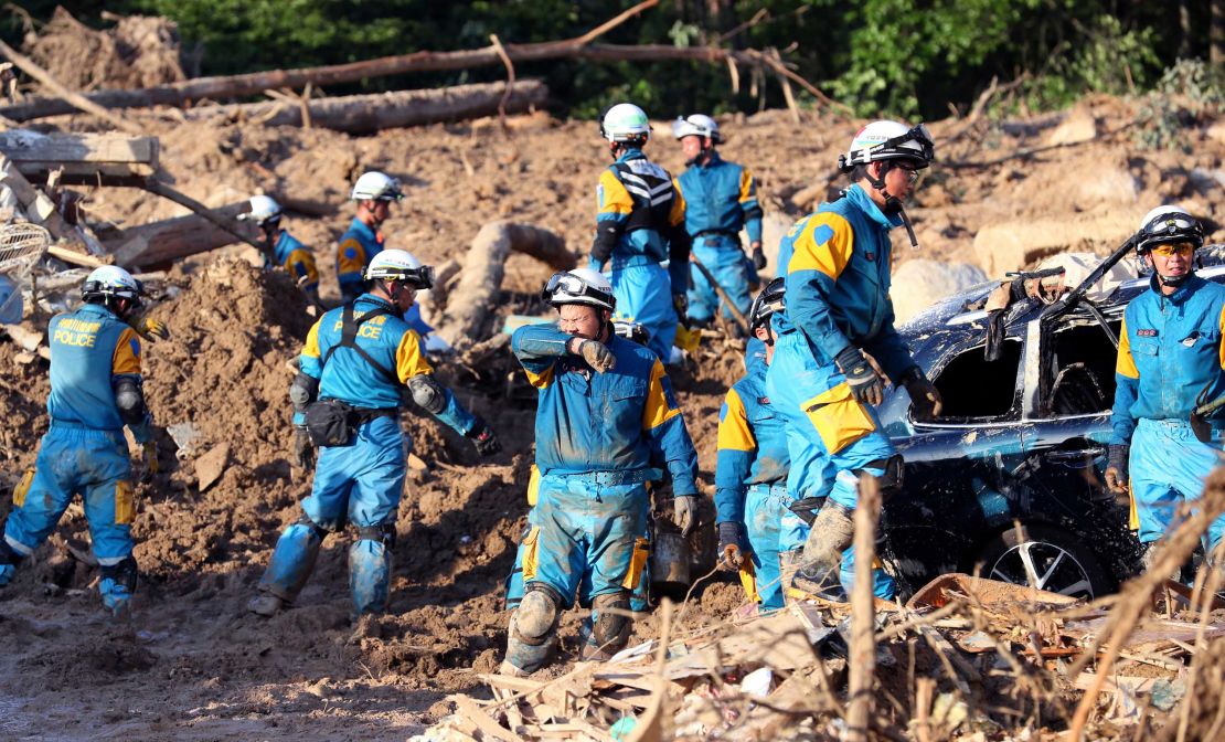 Police officers continue rescue operation in the sweltering heat at a landslide site on July 9 in Kumano, Hiroshima, Japan.