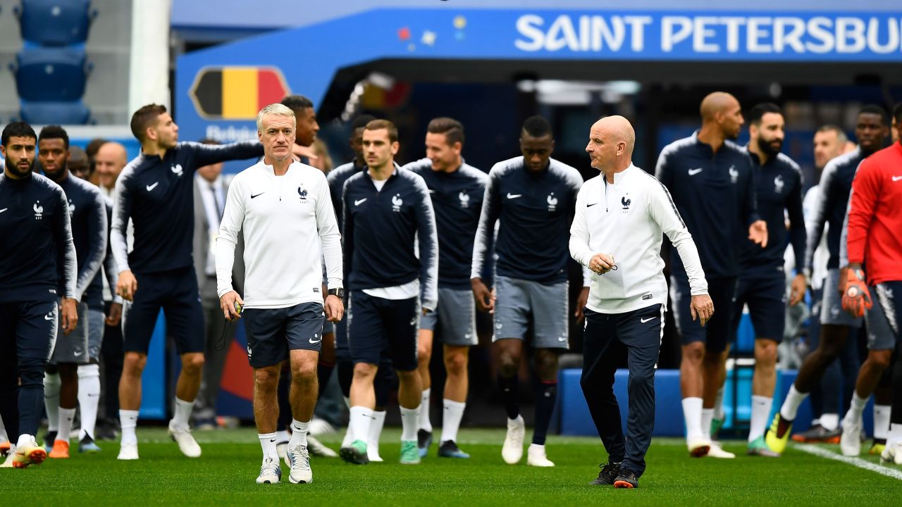 France's coach Didier Deschamps (L) and France's assistant coach Guy Stephan arrive with their players to lead a training session of France's national football team at the Saint Petersburg Stadium, in Saint Petersburg, on July 9, 2018, on the eve of their Russia 2018 World Cup semi-final football match against Belgium. (Photo by GABRIEL BOUYS / AFP)        (Photo credit should read GABRIEL BOUYS/AFP/Getty Images)