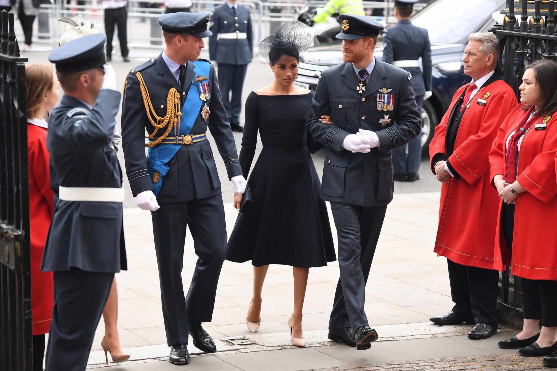 Prince William (L),  Prince Harry (R) and Meghan, Duchess of Sussex (C), arrive for the service.