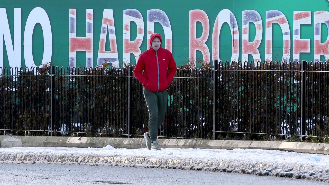 A pedestrian walks past a billboard in west Belfast on December 8, 2017 erected by Republican Party Sinn Fein calling for a special status for northern Ireland with respect to Brexit and no hard borders in Ireland.
Britain and the European Union reached a historic deal on Brexit divorce terms on Friday that allows them to open up talks on a future relationship after the split. The European Commission announced that it "recommends sufficient progress" had been made by Britain on separation issues including the Irish border, Britain's divorce bill, and citizens' rights.  / AFP PHOTO / Paul FAITH        (Photo credit should read PAUL FAITH/AFP/Getty Images)