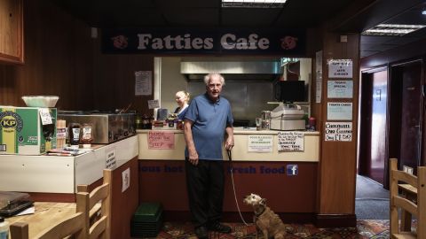 Matthew Allon and his dog Spike, pictured in Fatties Cafe, in the district of Concord in Washington, Sunderland on 9th July 2018. Pictured behind is Kelly Maughan who works in the cafe and has lived in Washington all her life. President Donald Tump is visiting the United Kingdom on Friday 13th July and is expected to be greeted with protests in London and around the country. Photograph by Mary Turner/ Panos Pictures