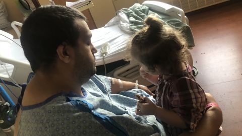 Barela, 30, holds his daughter Cataleya, now almost 2, during a hospitalization in January at Porter Adventist Hospital.