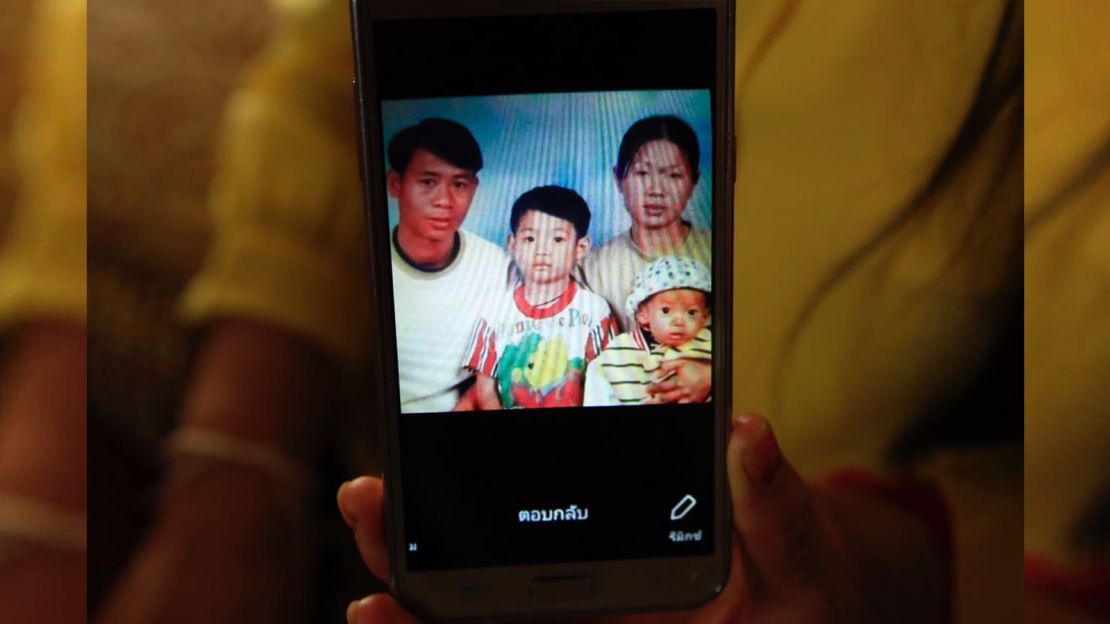 Soccer coach Ekkapol Ake Chantawong, seen here as a boy in the center of this photo with his late parents and younger brother.