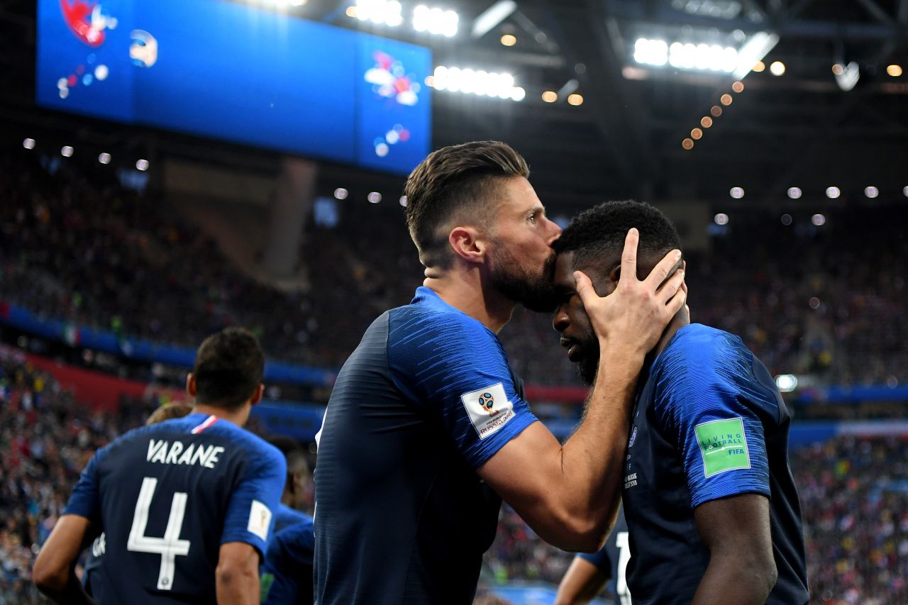 France's Olivier Giroud kisses teammate Samuel Umtiti after Umtiti scored on a header against Belgium.