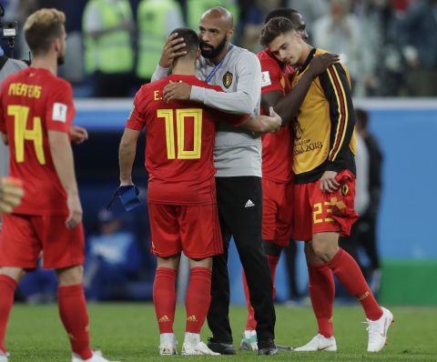 Thierry Henry, assistant coach for Belgium and former French captain, consoles Belgian players after the semifinal loss.
