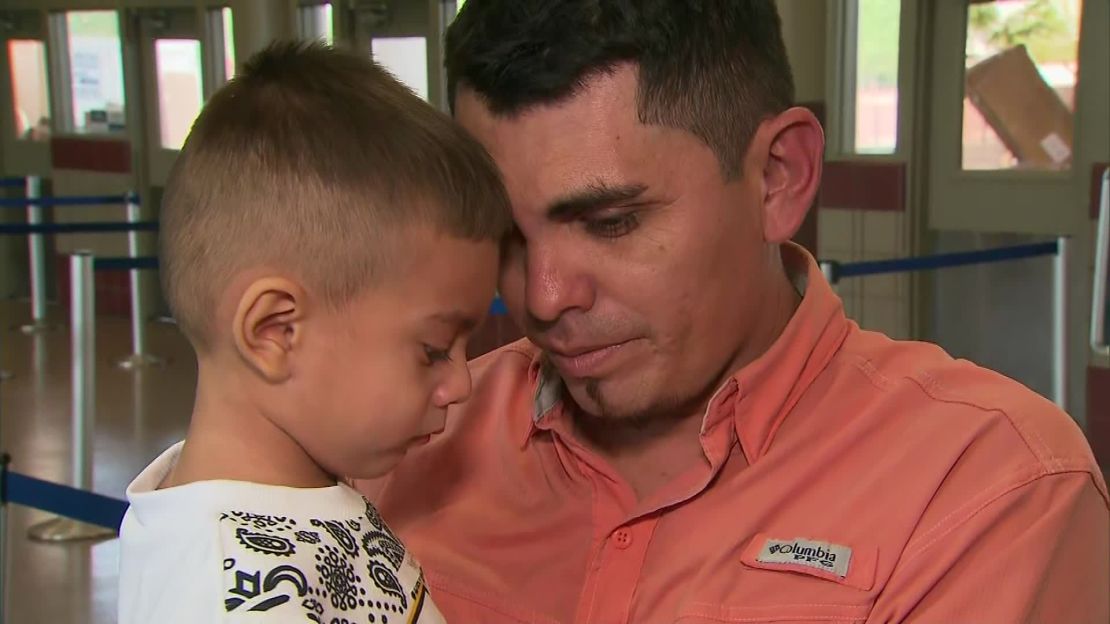Josue Rodriguez holds his 3-year-old son after being separated for 40 days.