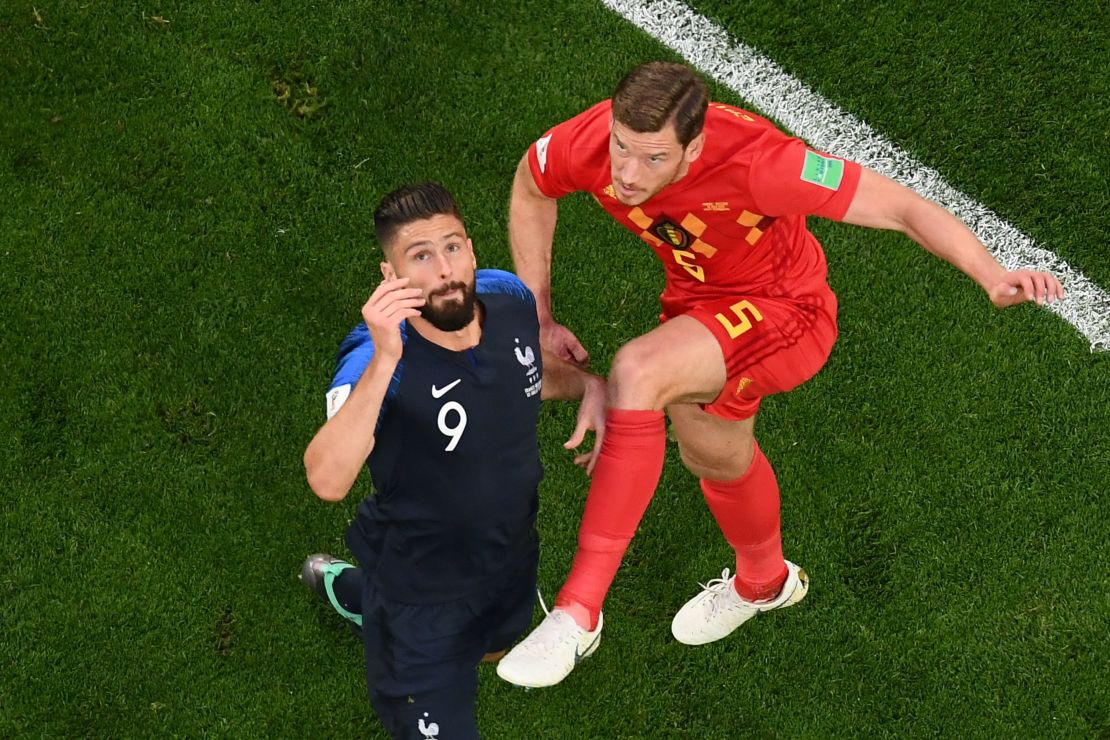 Franc forward Olivier Giroud (L) vies for the ball with Belgium's Jan Vertonghen.