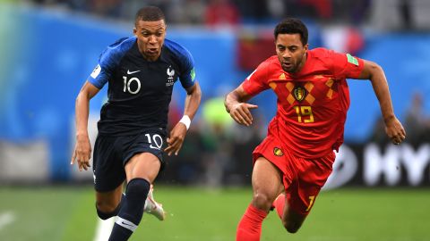 Kylian Mbappe of France runs with the ball under pressure from Moussa Dembele of Belgium.