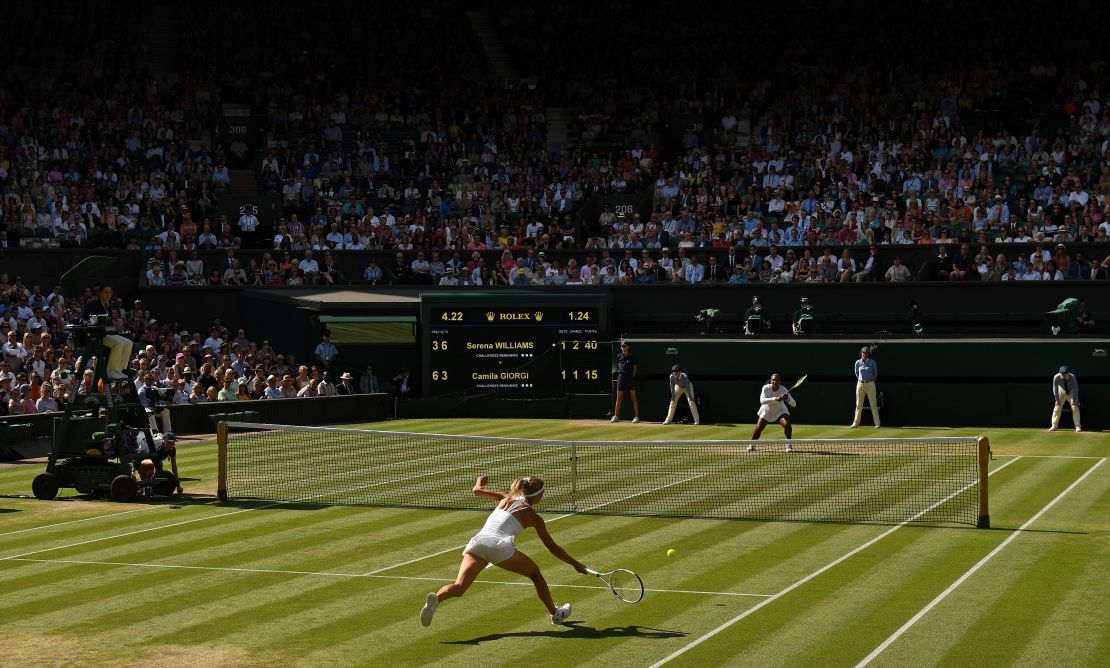 Camila Giorgi (bottom) goes for a shot against Serena Williams at Wimbledon. 