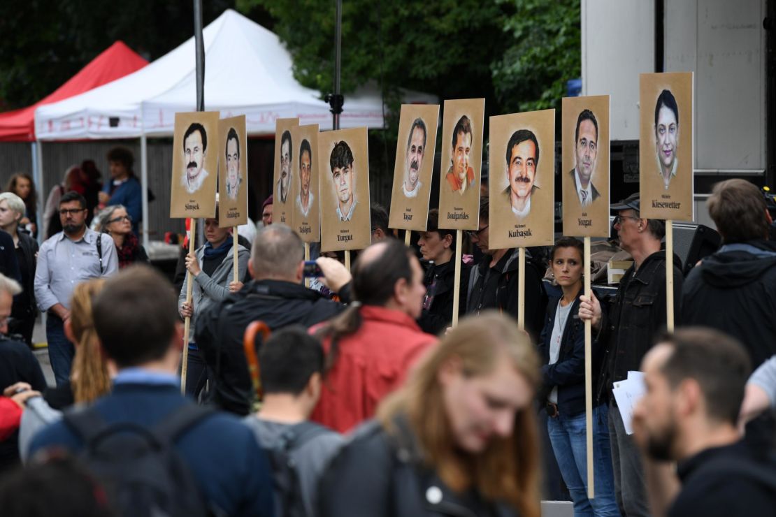 Activists hold banners with the portraits of the NSU victims outside the Munich courthouse Wednesday. 