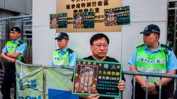 A protester (C) holds a sign of detained Chinese human rights lawyer Wang Quanzhang at a rally outside the Chinese Liaison Office in Hong Kong on April 5, 2018, to commemorate human rights activists and call for the release of political prisoners. / AFP PHOTO / ISAAC LAWRENCE        (Photo credit should read ISAAC LAWRENCE/AFP/Getty Images)