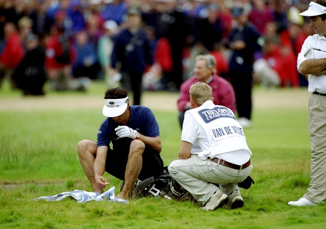 Drying his feet, Van de Velde contemplates his fifth shot on the final hole.