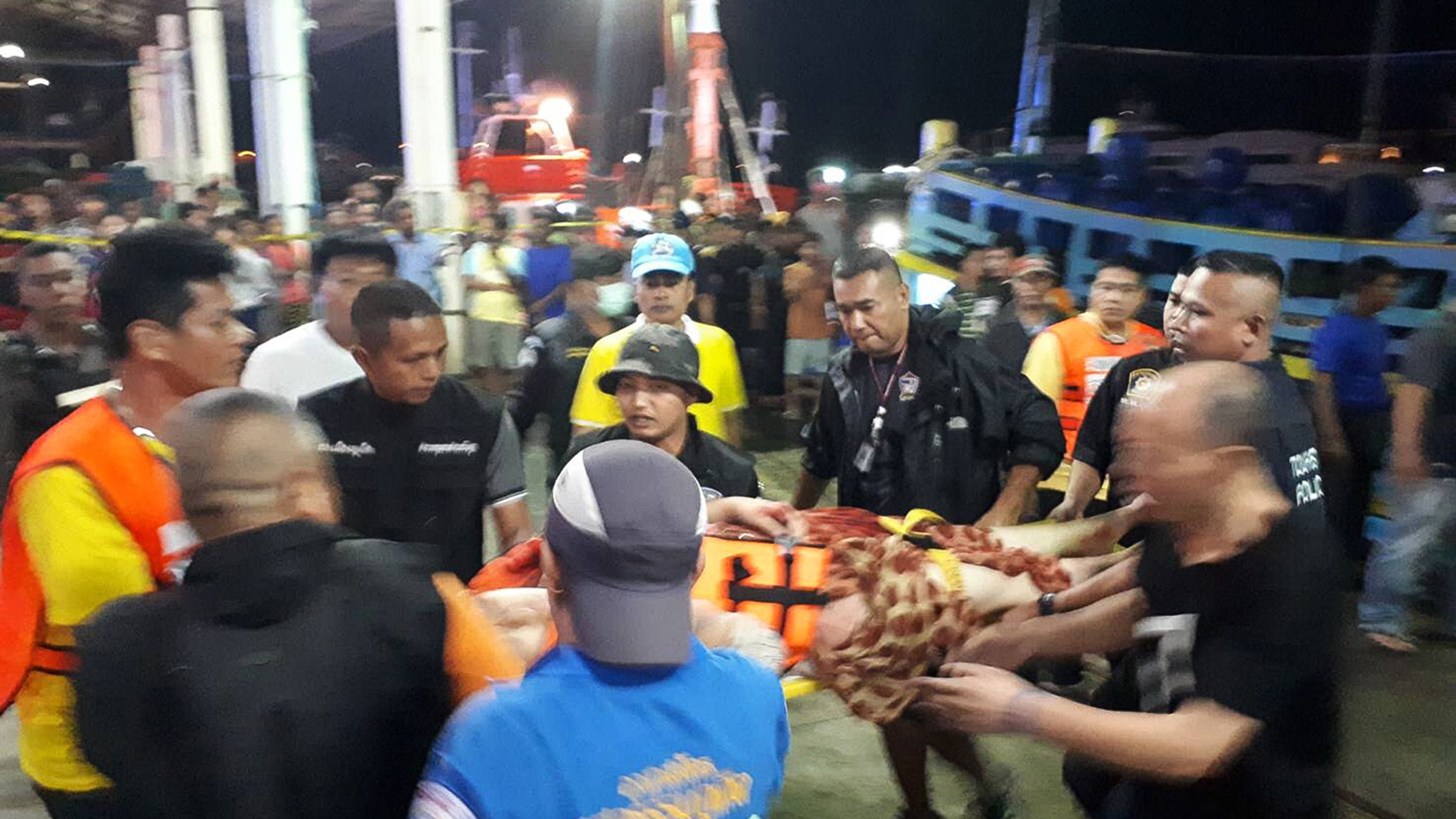 Thai rescue and paramedic personnel attend to rescued passengers of capsized tourist boat in rough seas at a port in Phuket on Thursday.
