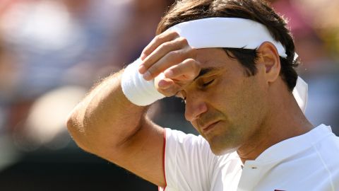 Roger Federer puts his hand to his brow.