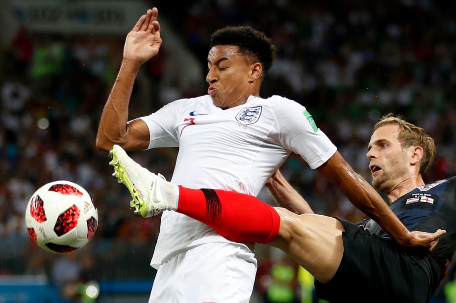 Croatia's Ivan Strinic, right, challenges England's Jesse Lingard.