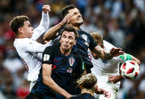 Players collide during the Croatia-England semifinal. Croatia played 120 minutes for the third straight match.