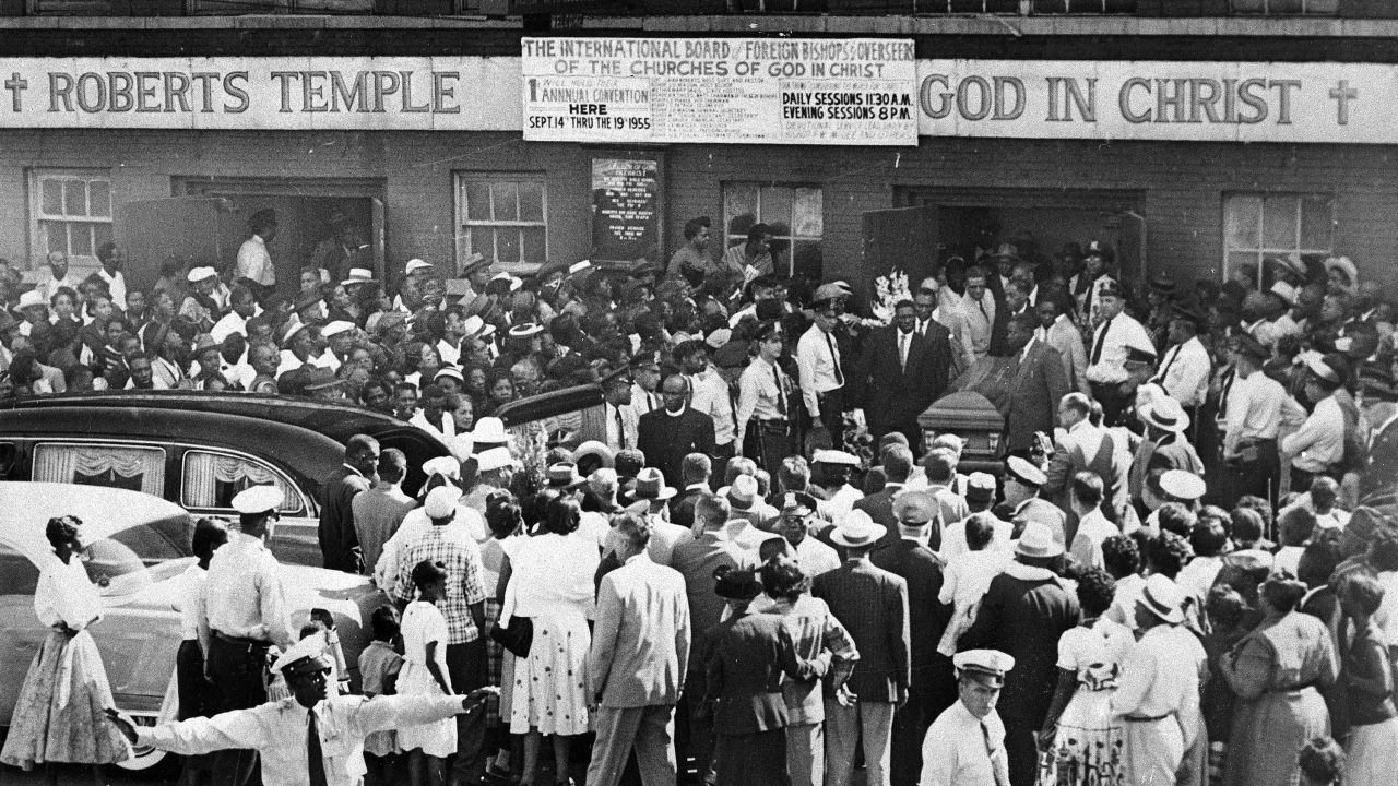 A crowd gathers outside the Roberts Temple Church of God In Christ in Chicago in 1955 as pallbearers carry the casket of Emmett Till.