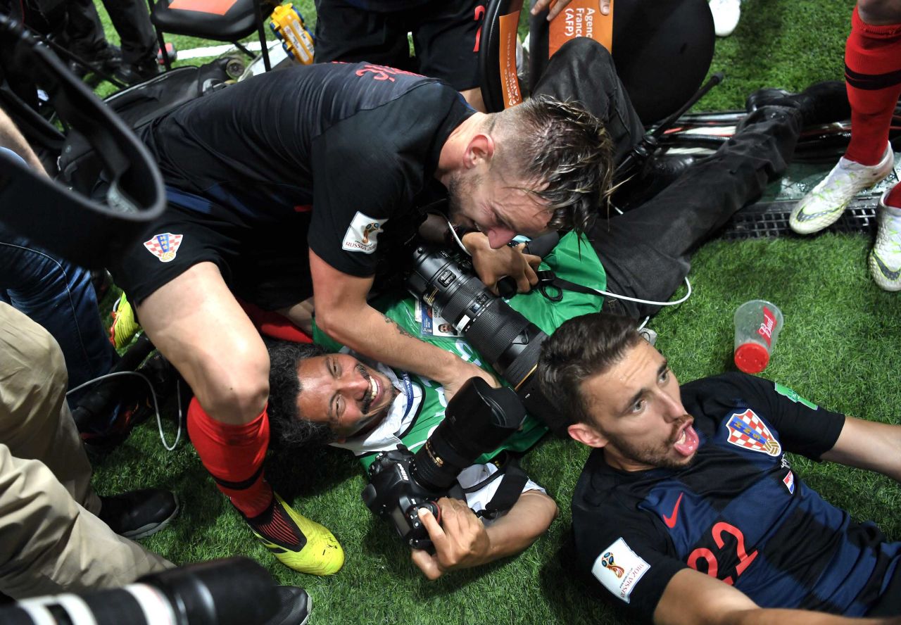 A photographer is knocked over by members of the Croatian team as they celebrate the late Mandzukic goal.
