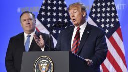 US President Donald Trump is flanked by Secretary of State Mike Pompeo, left, as he speaks during a press conference after a summit of heads of state and government at NATO headquarters in Brussels, Belgium, on Thursday.