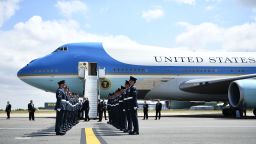 US President Donald Trump (C) and US First Lady Melania Trump are greeted by an honour guard of Royal Air Force personnel after disembarking Air Force One at Stansted Airport, north of London on July 12, 2018, as he begins his first visit to the UK as US president. - The four-day trip, which will include talks with Prime Minister Theresa May, tea with Queen Elizabeth II and a private weekend in Scotland, is set to be greeted by a leftist-organised mass protest in London on Friday. (Photo by Brendan Smialowski / AFP)        (Photo credit should read BRENDAN SMIALOWSKI/AFP/Getty Images)