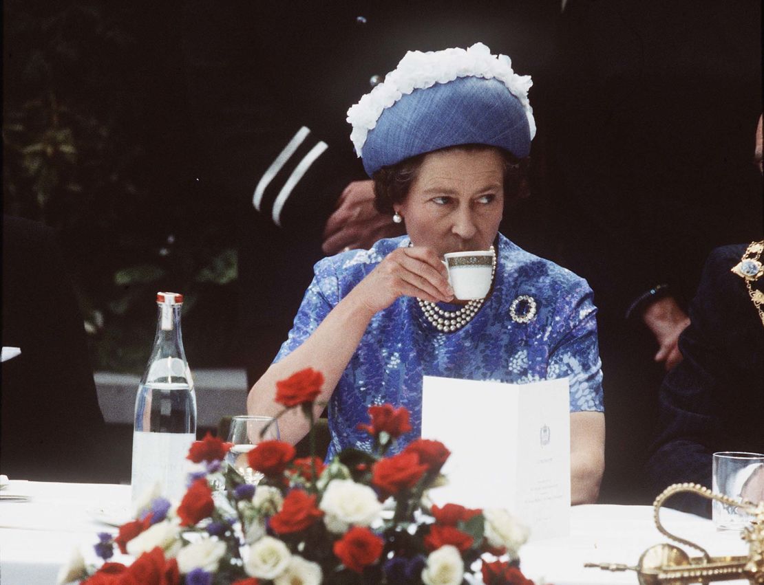 Queen Elizabeth ll having a cup of tea in Northern Ireland on a royal visit in 1977.