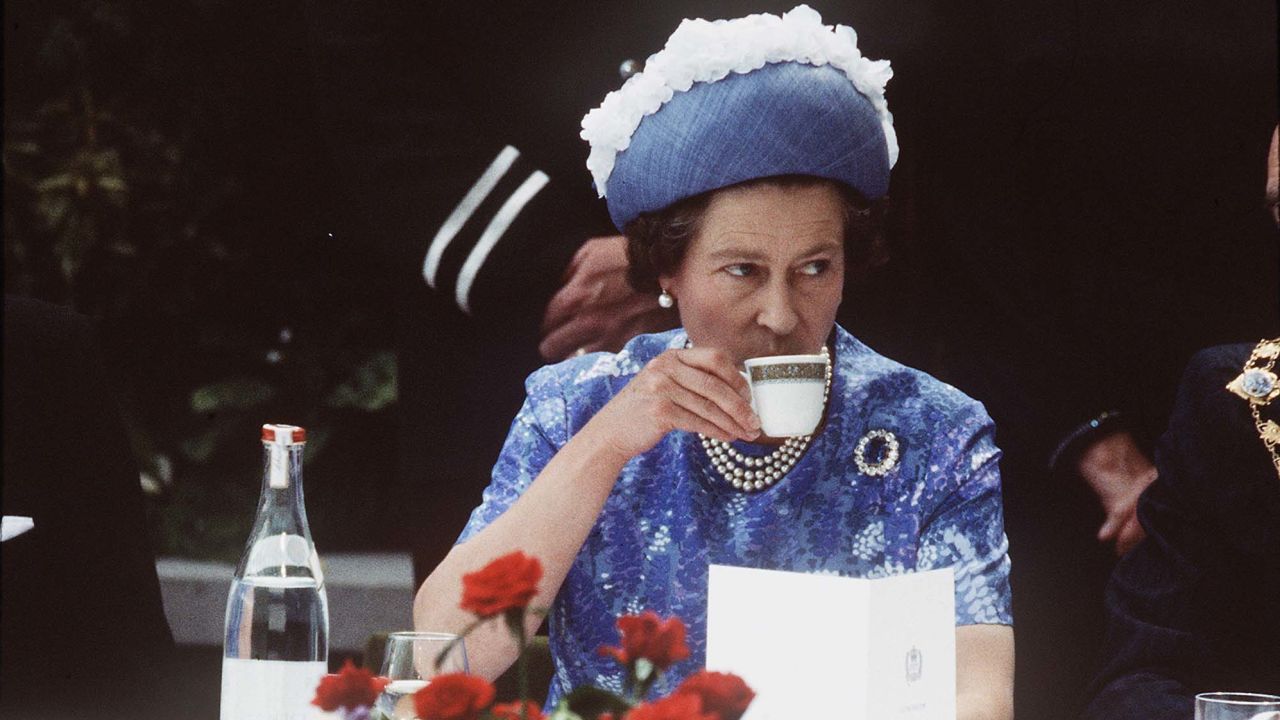 Queen Elizabeth ll having a cup of tea in Northern Ireland on a royal visit in 1977.