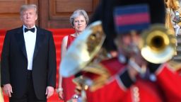 Britain's Prime Minister Theresa May (2L) stands with US President Donald Trump (L) on steps in the Great Court watching and listening to the bands of the Scots, Irish and Welsh Guards perform a ceremonial welcome as they arrive for a black-tie dinner with business leaders at Blenheim Palace, west of London, on July 12, 2018, on the first day of President Trump's visit to the UK. - The four-day trip, which will include talks with Prime Minister Theresa May, tea with Queen Elizabeth II and a private weekend in Scotland, is set to be greeted by a leftist-organised mass protest in London on Friday. (Photo by Ben STANSALL / POOL / AFP)        (Photo credit should read BEN STANSALL/AFP/Getty Images)