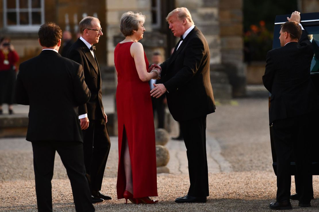 Britain's Prime Minister Theresa May shakes hands with US President Donald Trump as Philip May looks on.
Trump's four-day trip is his first visit to the UK as president.