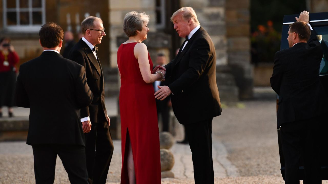 Britain's Prime Minister Theresa May shakes hands with US President Donald Trump as Philip May looks on.
Trump's four-day trip is his first visit to the UK as president.