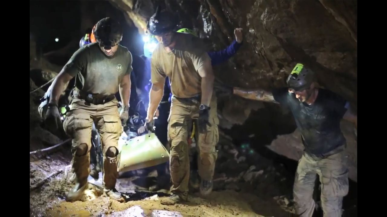 Rescue personnel  carry a member of the "Wild Boars" Thai youth football team on a stretcher during the rescue operation inside the Tham Luang cave. 