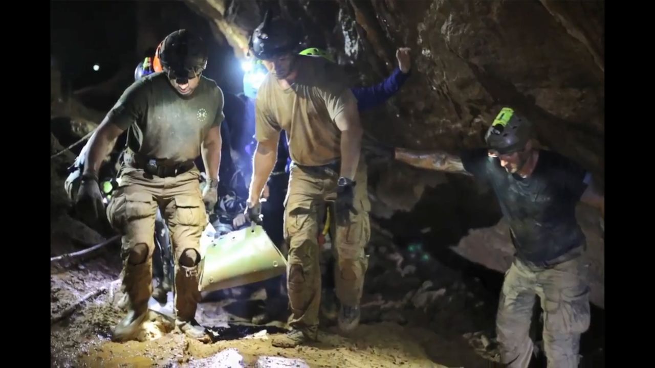 Rescue personnel carry a member of the "Wild Boars" Thai youth football team on a stretcher during the rescue operation inside the Tham Luang cave.